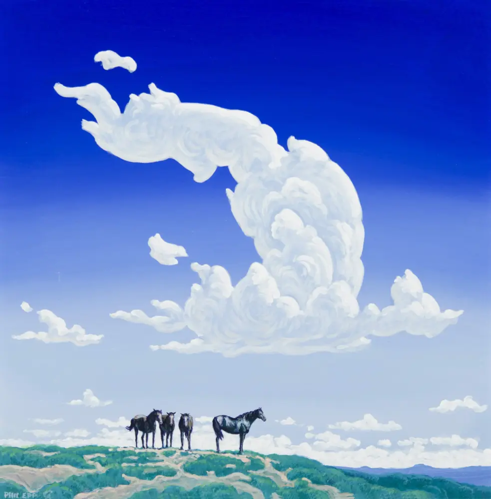 Line of horses standing on a cloud-covered hill beneath a bright blue sky with white clouds.