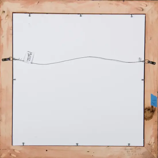 Back of a framed canvas with a metal hanging wire attached to the wooden stretcher and metal brackets on the frame; a small tag with numbers is visible on the left side.