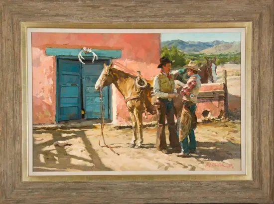 Two cowboys talk beside a saddled horse in a sunlit desert yard with a pink adobe wall and blue door, mountains in the distance.