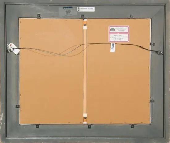 Back of a framed artwork showing a brown backing, a hanging wire stretched across, and inventory labels on the right side of the frame.