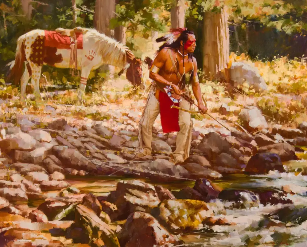 Indigenous hunter in traditional dress stands on a rocky riverbank, drawing a bow, with a white-spotted horse tied nearby in a forest setting.