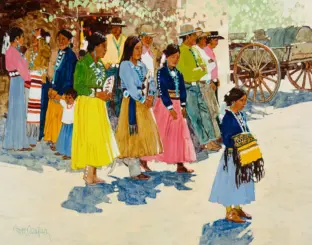 Line of Indigenous women and children in bright traditional dresses and bead necklaces, outdoors near wagon wheels in the background.