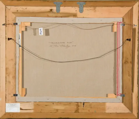 Back of a stretched canvas in a wooden frame, hanging wire attached across top, with a label reading 'Troublesome Sign'.