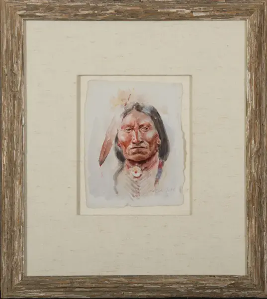 Watercolor portrait of a Native American man with long hair and a feather headdress, framed with a rustic wood frame.