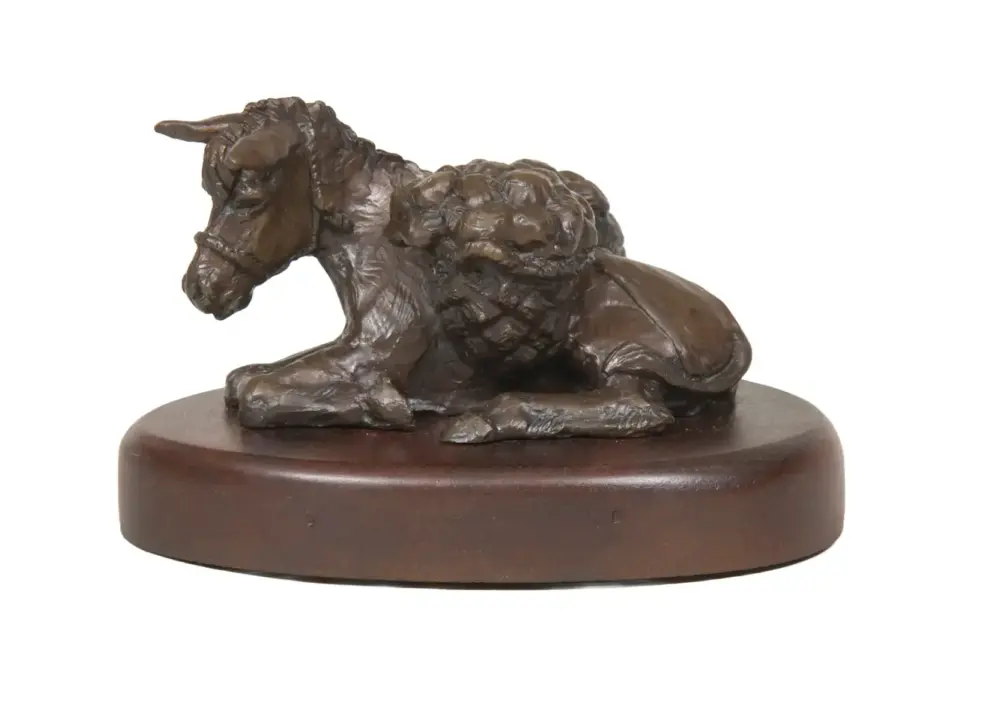 Bronze horse statue kneeling on a round wooden base with a dark brown patina