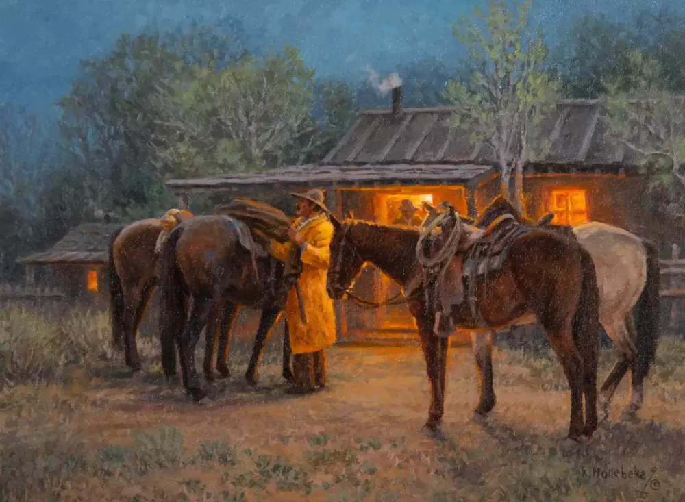 Evening scene of a man in a yellow coat tending horses outside a warmly lit stable.