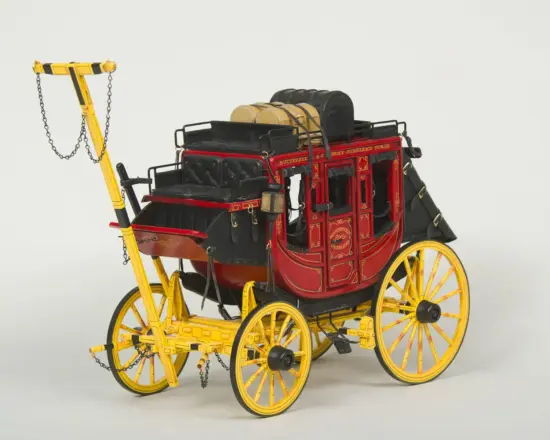 Decorative antique horse-drawn carriage with a red body, black interior, and bright yellow wheels and frame, featuring leather straps and ornamental gold detailing