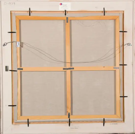 Back of a framed canvas showing wooden stretcher bars, hanging wires, and metal brackets.