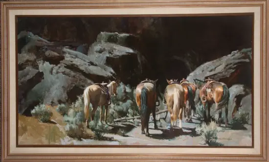 Framed painting of a herd of horses walking along a rocky, shadowy canyon path.