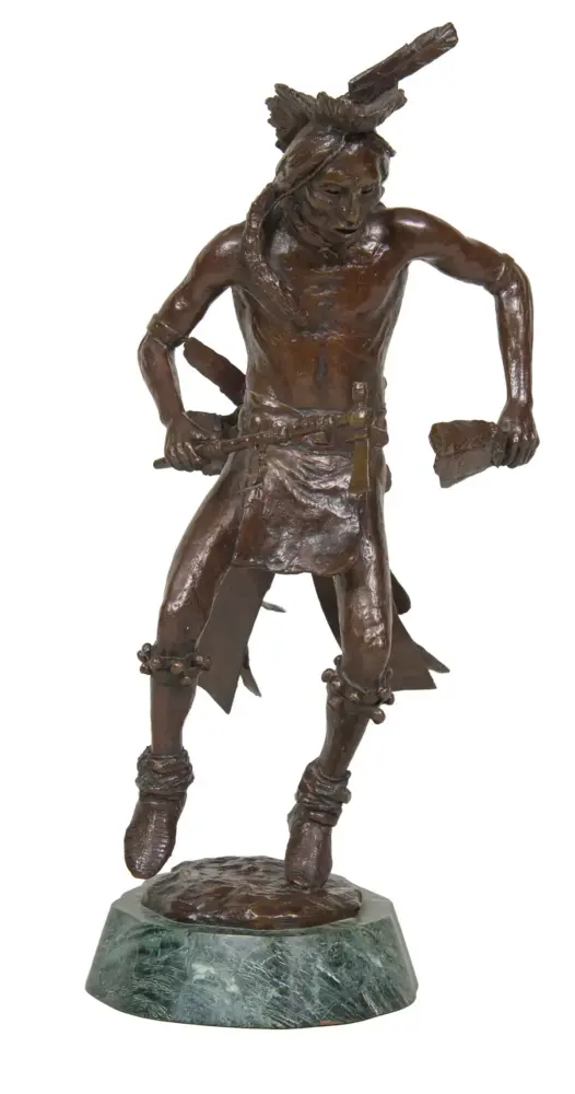 Bronze statue of a Native American hunter in a dynamic pose, wearing a headband and loincloth, holding a tomahawk and a carved club, standing on a green marble base.