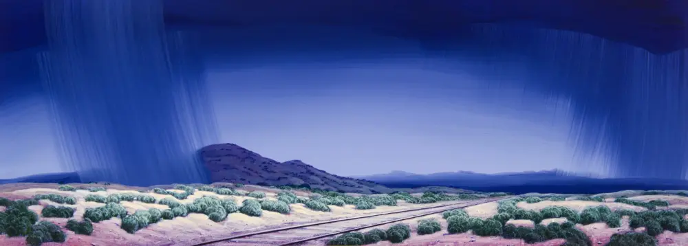 Desert scene with railroad tracks and low shrubs under a towering blue storm cloud and rainfall curtain.