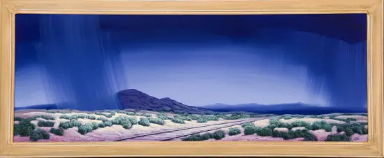 Framed desert landscape painting with scrubby bushes, railroad tracks, and a dramatic deep-blue stormy sky with rain.