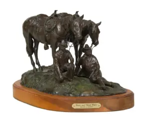 Bronze sculpture of two seated cowboys with horses on a rocky base, mounted on a wooden pedestal. Plaque reads 'Grass and Good Water' by Melvin C. Warren.