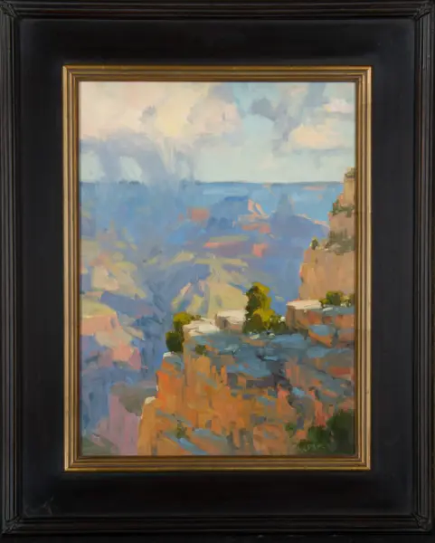 Impressionist seascape painting of blue ocean, pale sky, and rocky cliffs, framed in a black frame with gold inner trim.