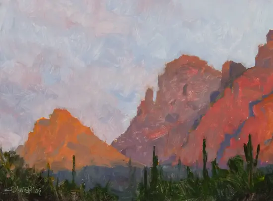 Impressionistic desert landscape with orange-red mountains under a pale blue sky and dark green foreground cacti or shrubs.