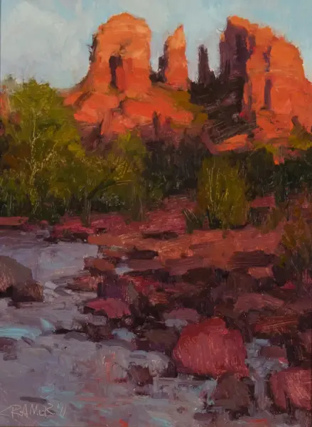 Textured landscape painting of red rock formations rising above green brush and a rocky foreground under a light blue sky.