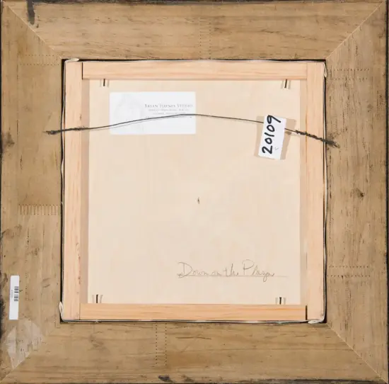 Back of a framed artwork: wooden frame, hanging wire, and a white label from Bryan Haynes Studio; tag reads '20/0' and the title 'Down on the Plaza' is hand-written on the back