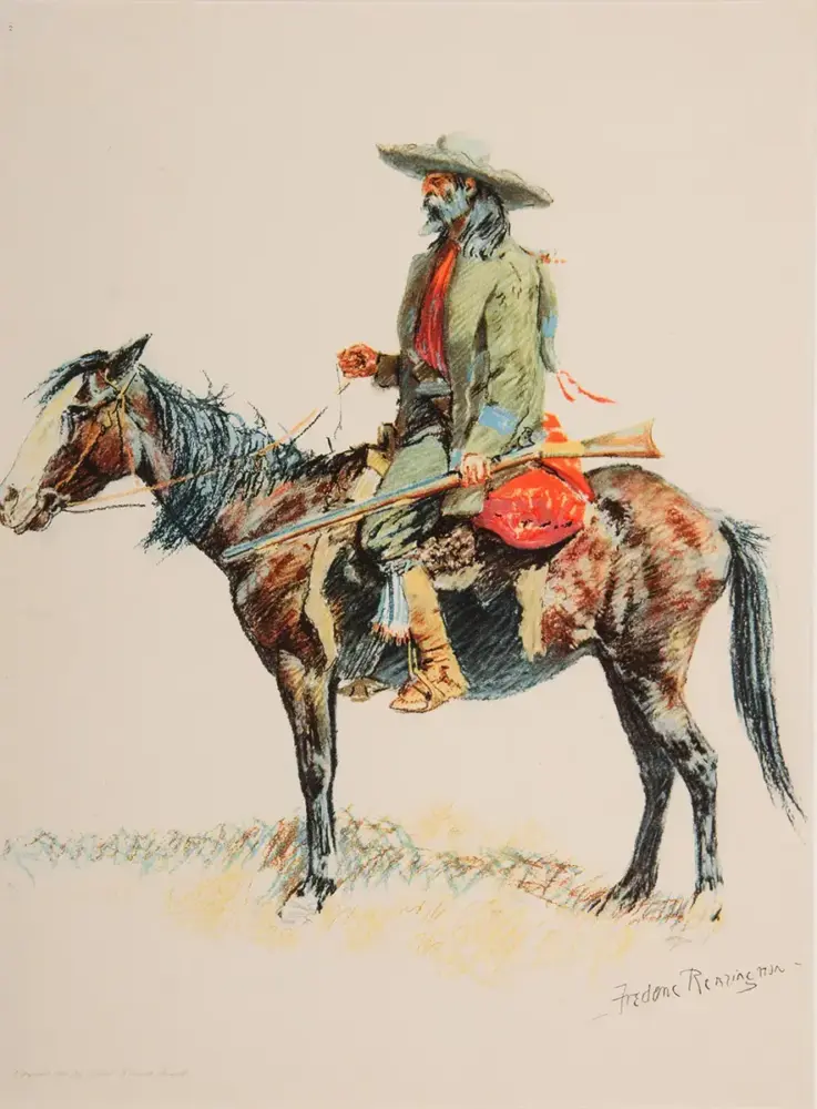 Cowboy on a brown horse, wearing a wide-brimmed hat and red scarf, holding the reins with a rifle at the saddle.