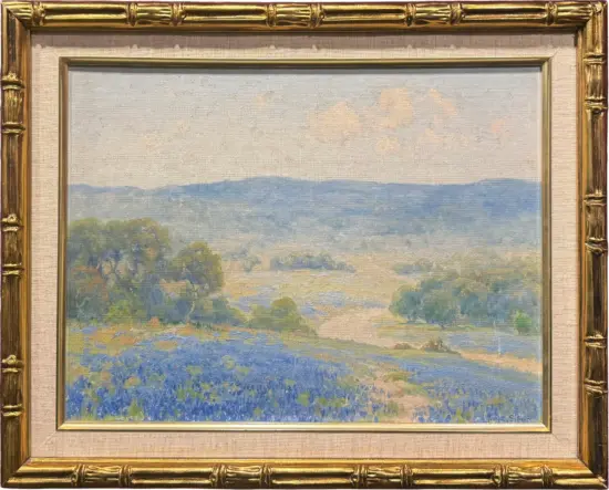 Impressionist landscape painting in a gold ornate frame, showing blue hills, pale sky, and a green foreground.
