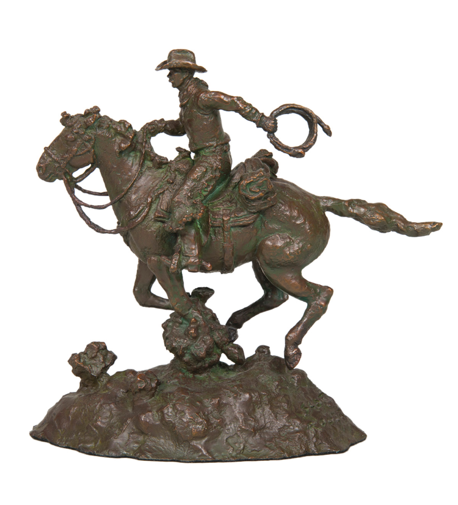 Bronze statue of a cowboy on a rearing horse, lasso in the air, mounted on a rocky base.