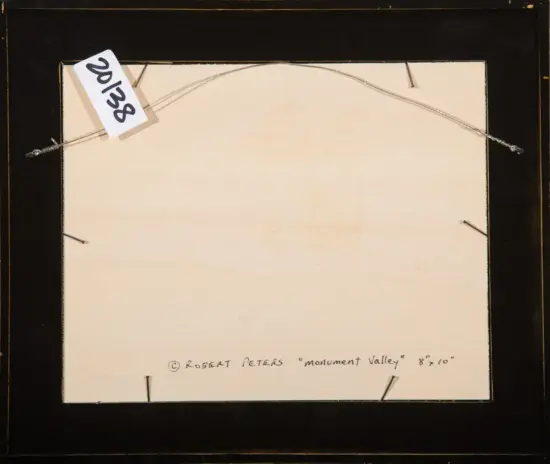 Back of a framed artwork with hanging wire, a white tag reading '2018', and handwritten title at bottom: Robert Peters 'Monument Valley' 8x10