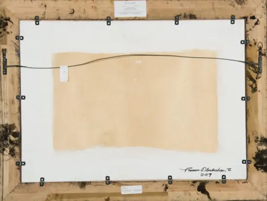 Back of a framed painting showing a hanging wire, metal brackets, and beige canvas on white backing with a wooden shipping crate frame nearby.