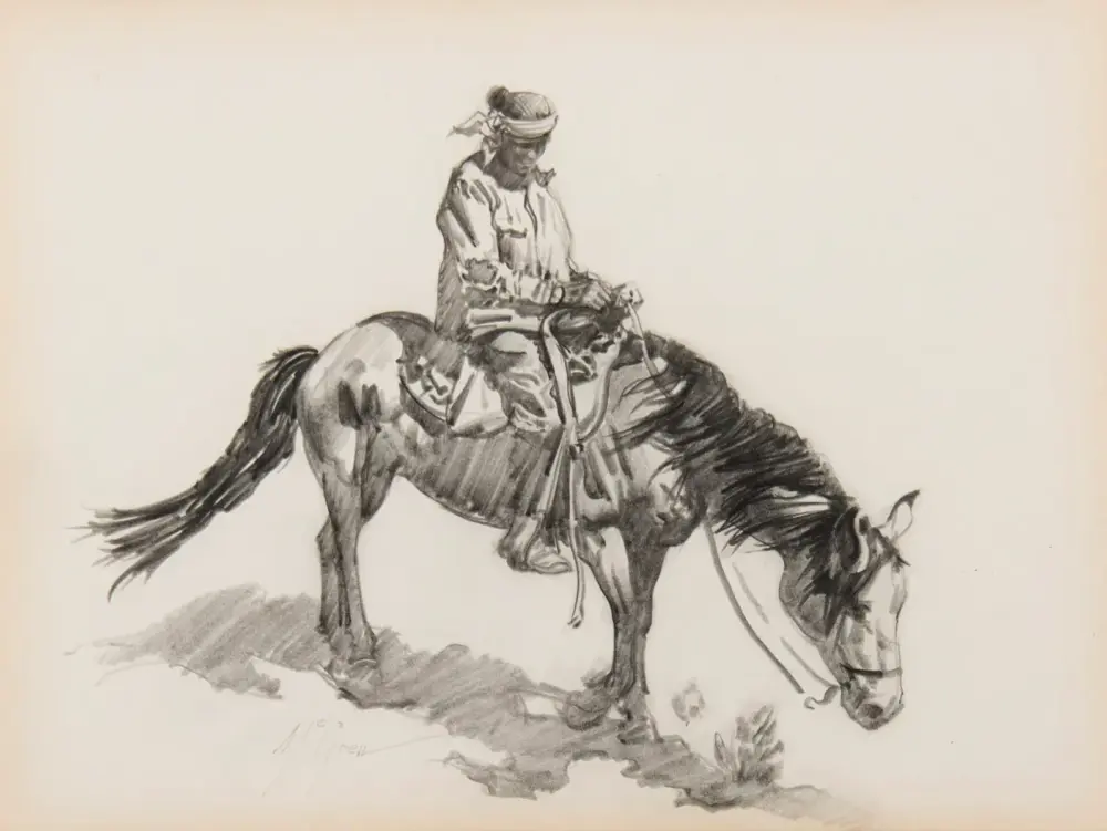 A rider in a hat and bandana on a saddled horse with its head bowed, grazing.
