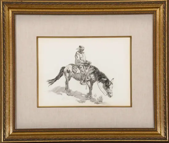 Framed black-and-white pencil sketch of a rider on a horse, mounted on a beige mat with a gold frame.