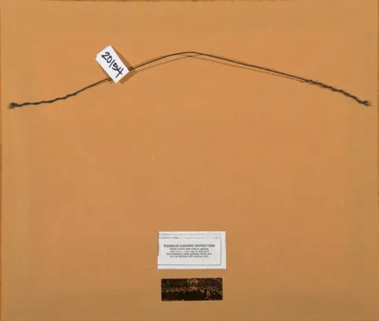 Back of a framed piece with a hanging wire and a white tag reading '2014' on the wire; a small cleaning instruction label below.