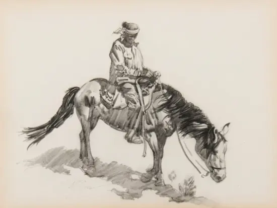 A rider in a hat and bandana on a saddled horse with its head bowed, grazing.