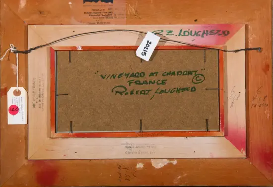 Back of a framed painting: rope for hanging, wooden frame, labels and handwritten title 'Vineyard at Chadat, France' visible on the back.