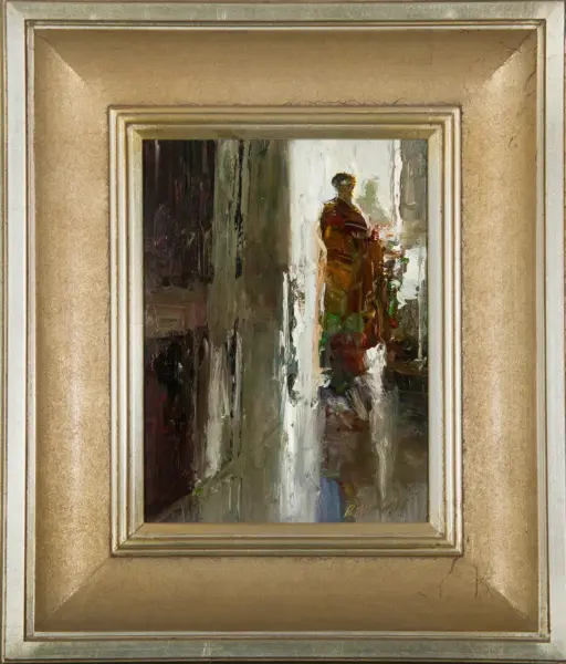 Abstract impressionist painting of a solitary figure in a brown-red cloak standing in a sunlit narrow alley, framed in a gold ornate frame.