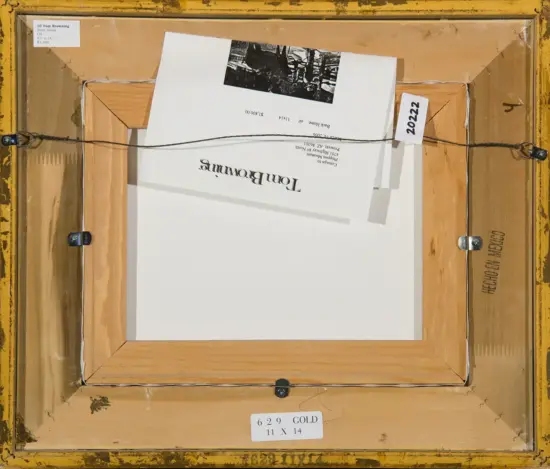 Back of a framed artwork with a hanging wire, wood frame, and labels noting its 11×14 size and inventory information.