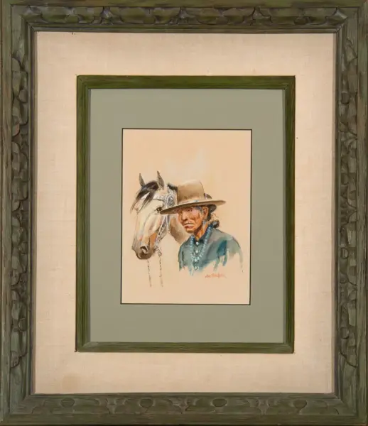 Watercolor portrait of a cowboy in a wide-brimmed hat beside a light-colored horse, framed with a green mat and carved green frame.