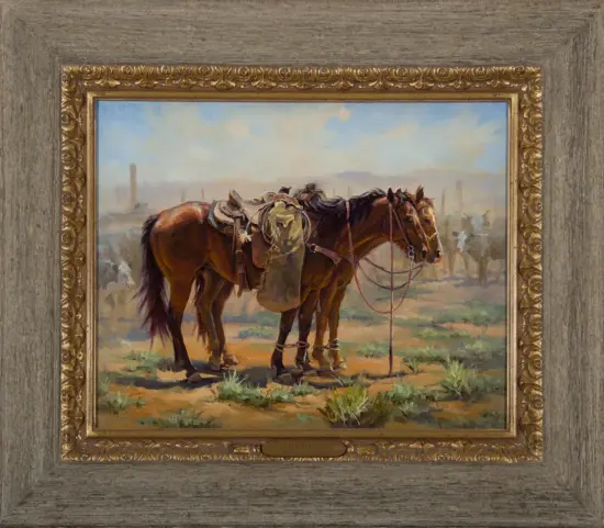 Two saddled horses standing together in a dusty western landscape, framed by an ornate gold frame and gray wood border.