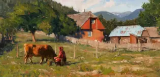 Rural scene with a person in red tending a brown cow in a grassy field near a wooden fence, farm buildings in the background. A mountain range behind trees in daylight.
