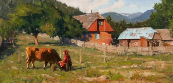 Rural scene with a person in red tending a brown cow in a grassy field near a wooden fence, farm buildings in the background. A mountain range behind trees in daylight.