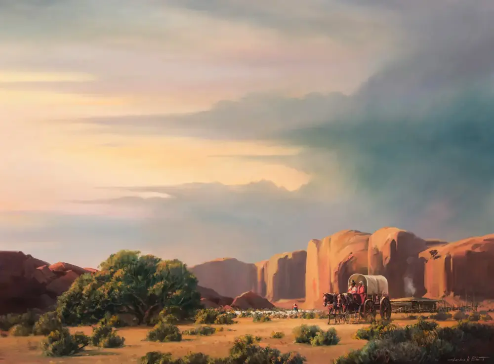 A cowboy wagon travels across a desert with rugged rock formations under a pastel sunset sky.