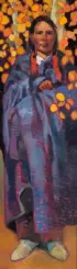 A woman in a blue and purple coat stands among orange autumn leaves, looking at the camera with a calm expression.