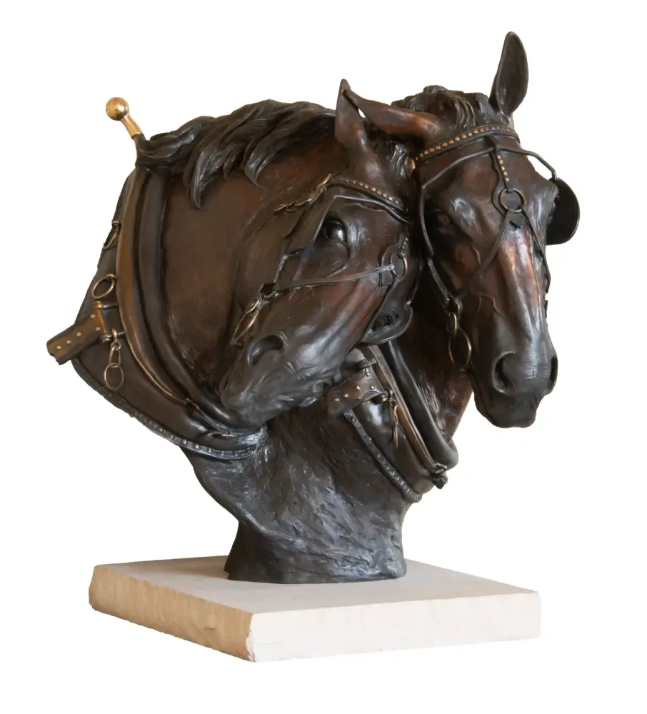 Bronze horse head bust with bridle on a light rectangular pedestal.