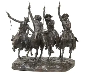 Bronze sculpture of four cowboys on galloping horses, raising pistols in the air on a rocky base