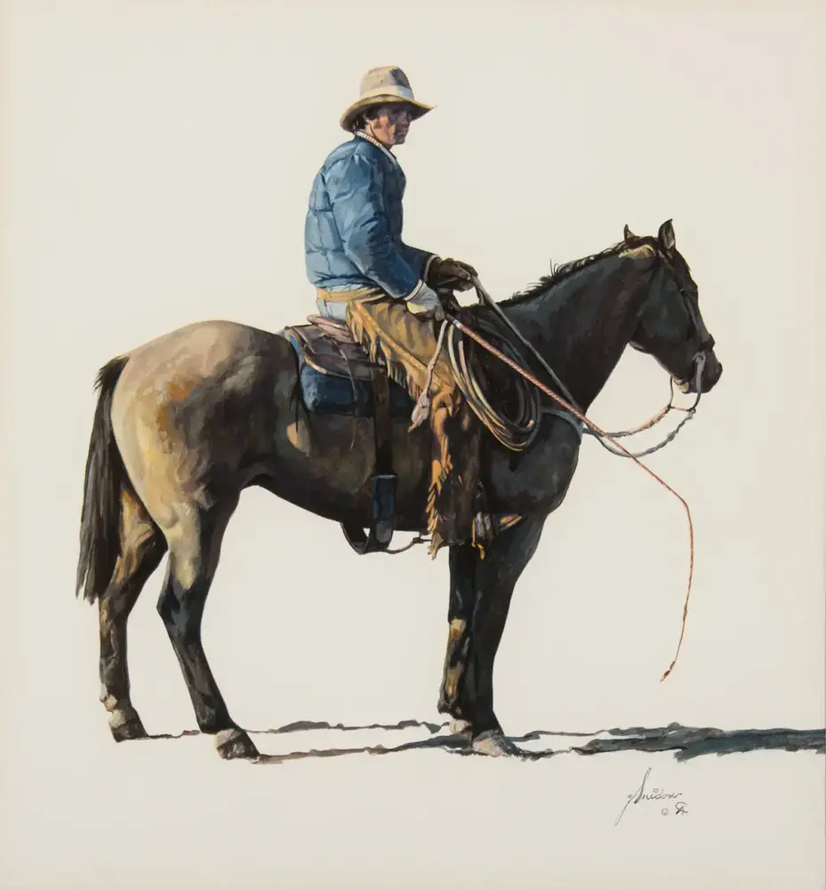Cowboy in a blue jacket and hat sits on a saddled dark horse, holding the reins.