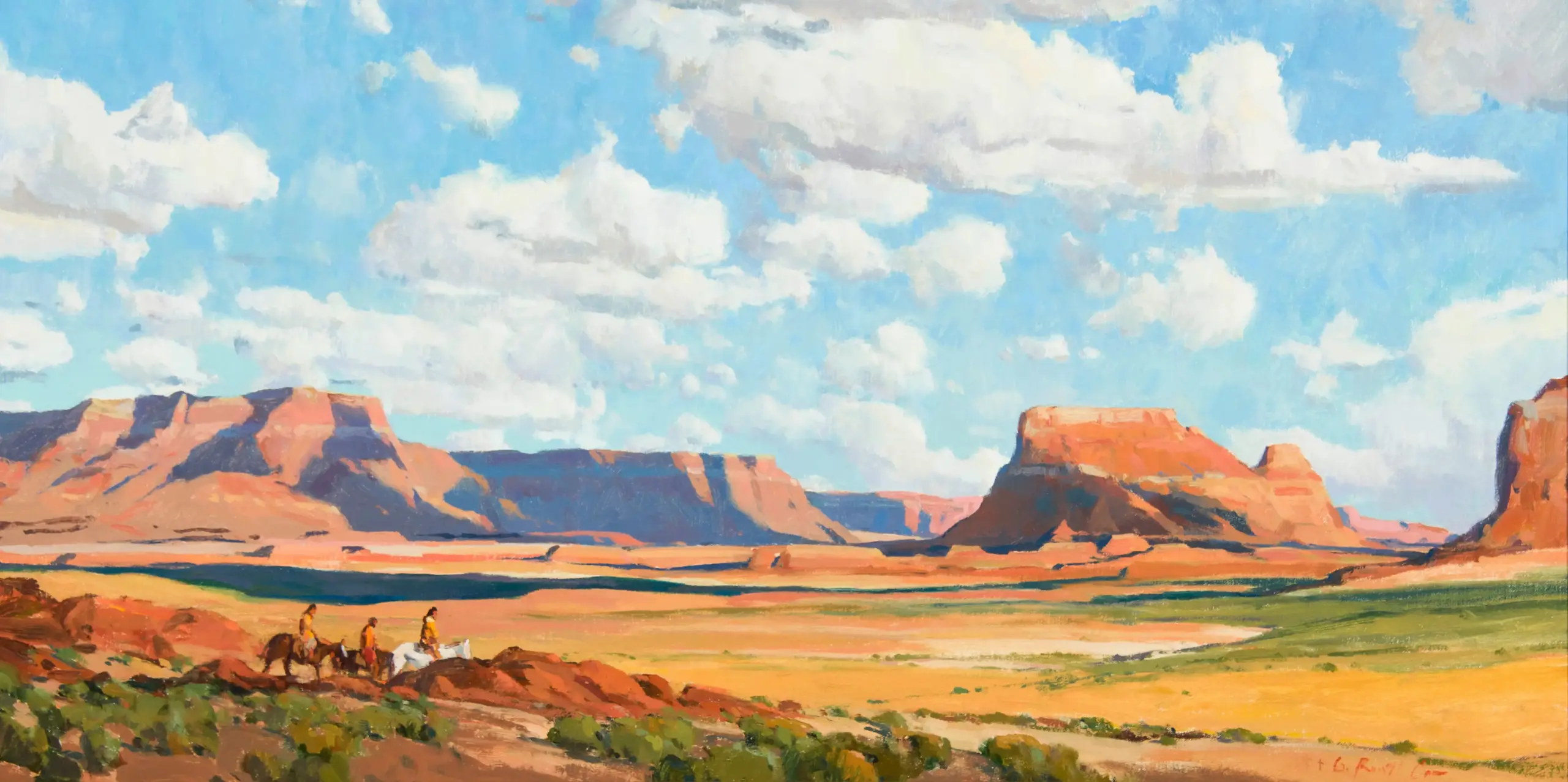 Desert canyon landscape with red rock mesas under a bright blue sky and fluffy clouds; a small group of people on horseback in the foreground.