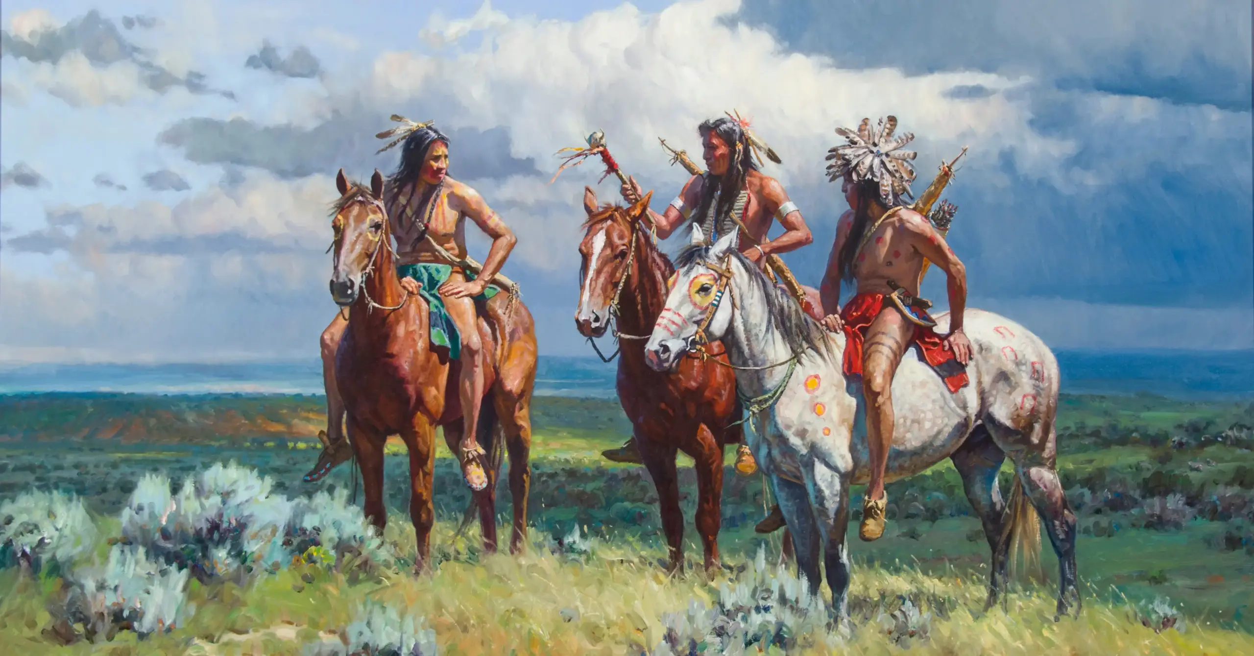 Four Native American riders on horses pause in a grassy, coastal plain under a cloudy sky.